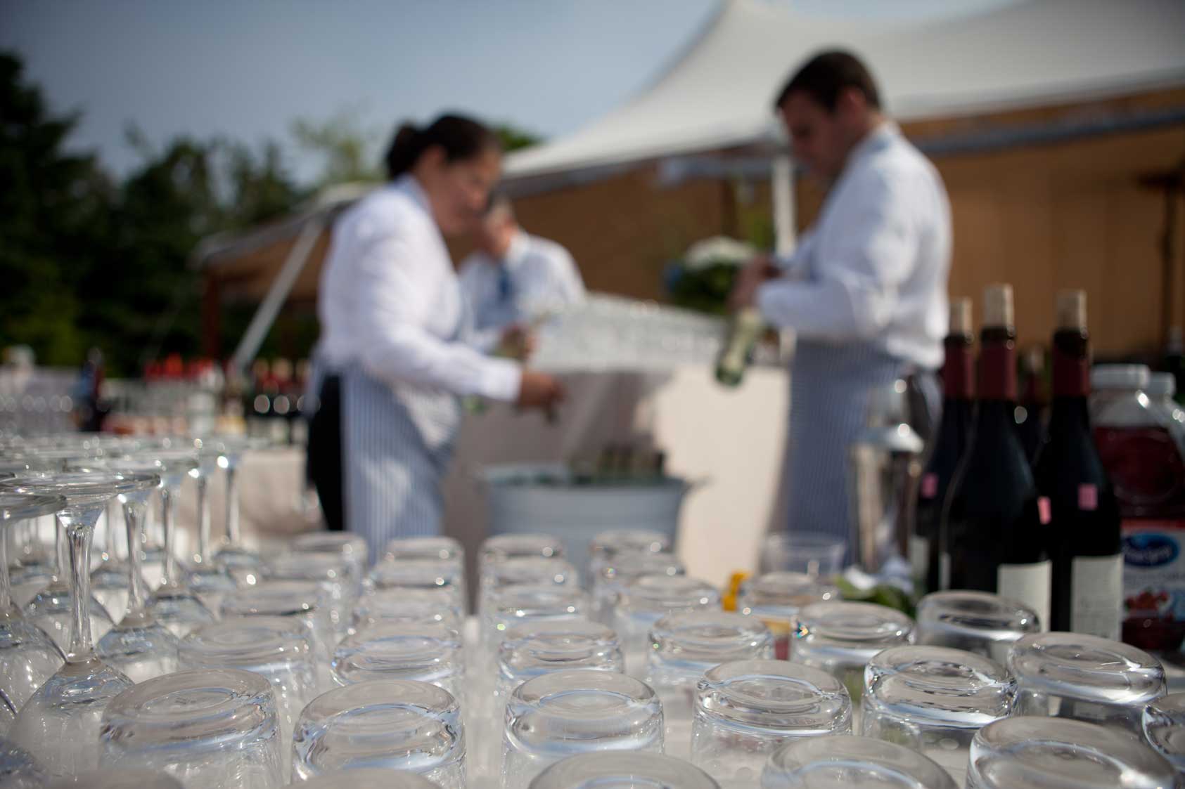 An array of glasses await full bar service at a Maine coastal wedding. www.churchillevents.com